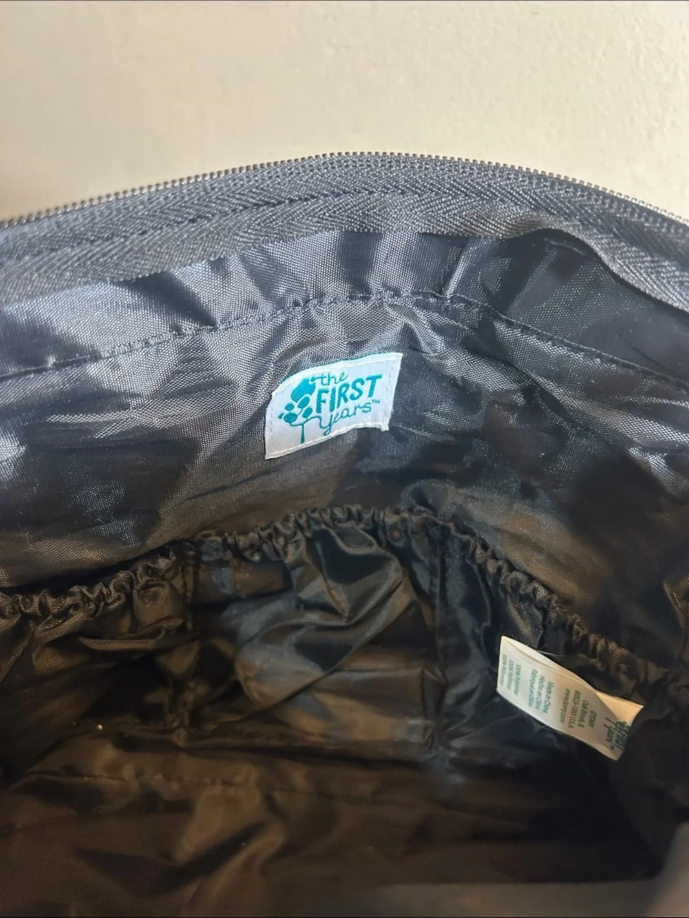 The First Years black and grey patterned canvas diaper bag tote